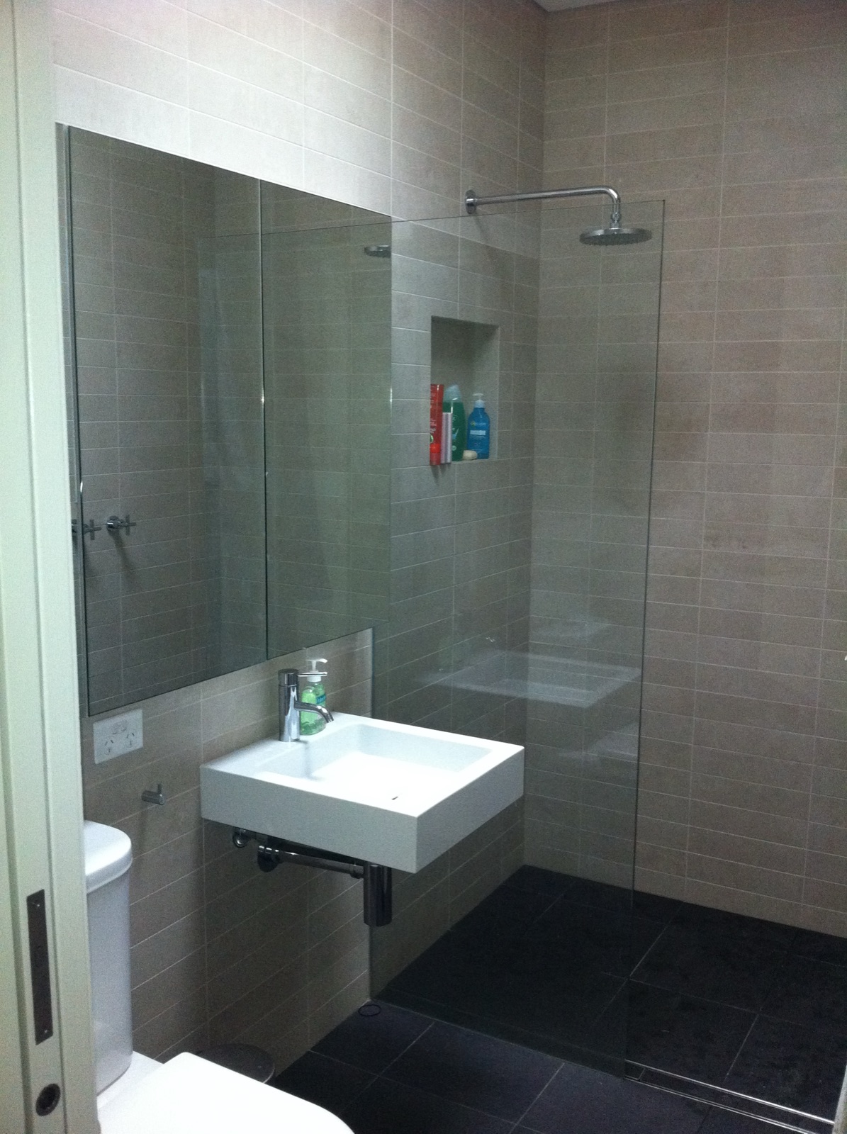 Main bathroom renovation with a walk-in shower, stone-look tiles and wall-hung basin in Surry Hills